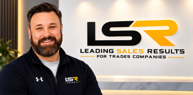 Adam Snider, Founder of Leading Sales Results, standing beside the company logo wall in the office